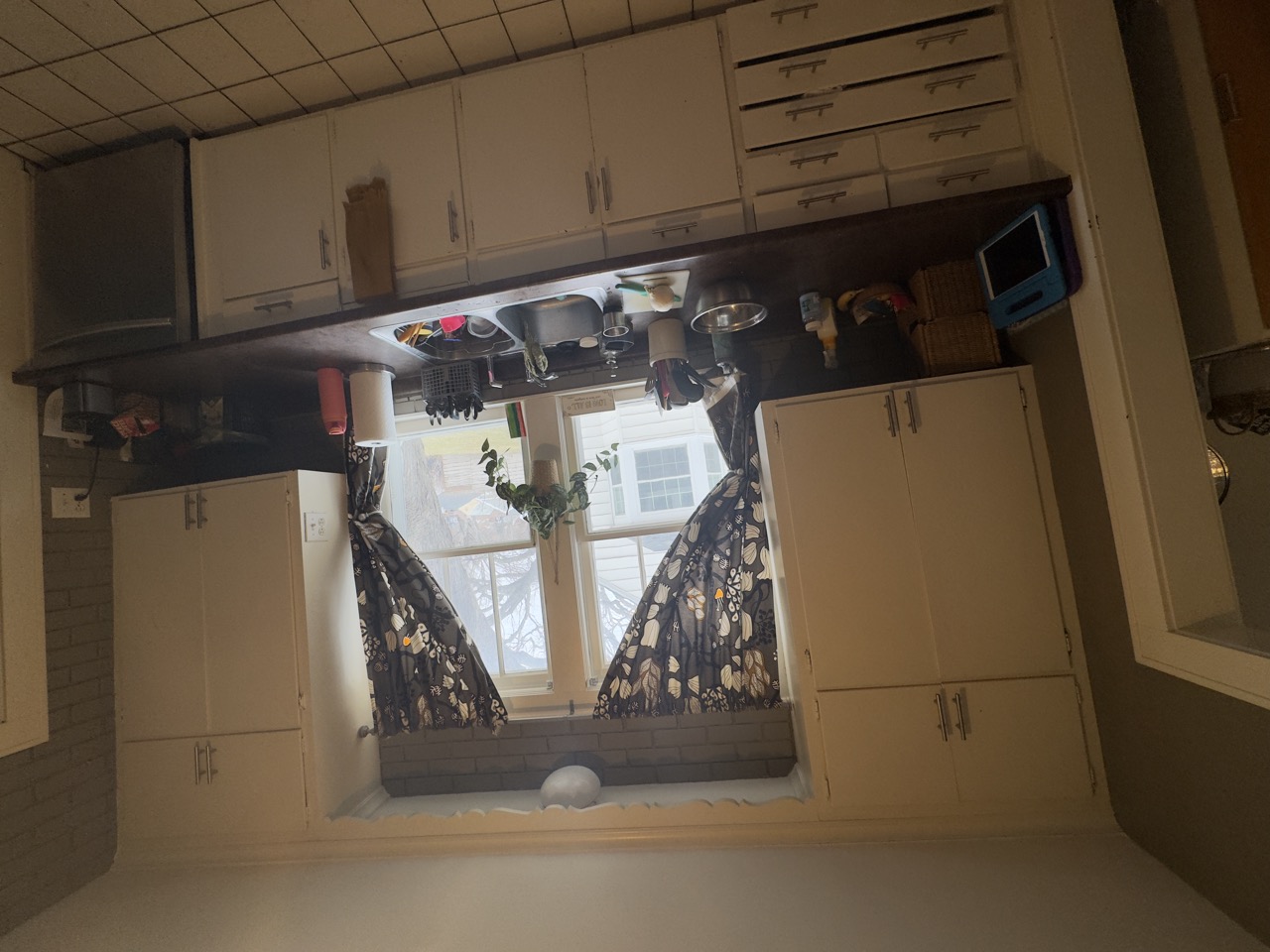 Kitchen before remodel — dated cabinets and counters