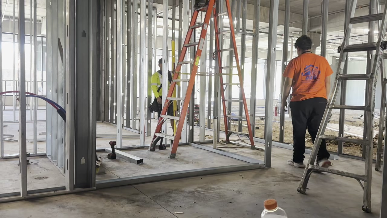 Metal stud framing in commercial building with crew