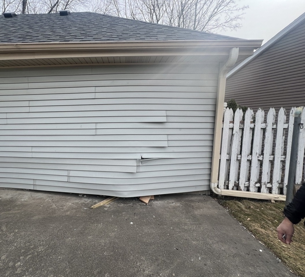 Damaged exterior siding — insurance claim