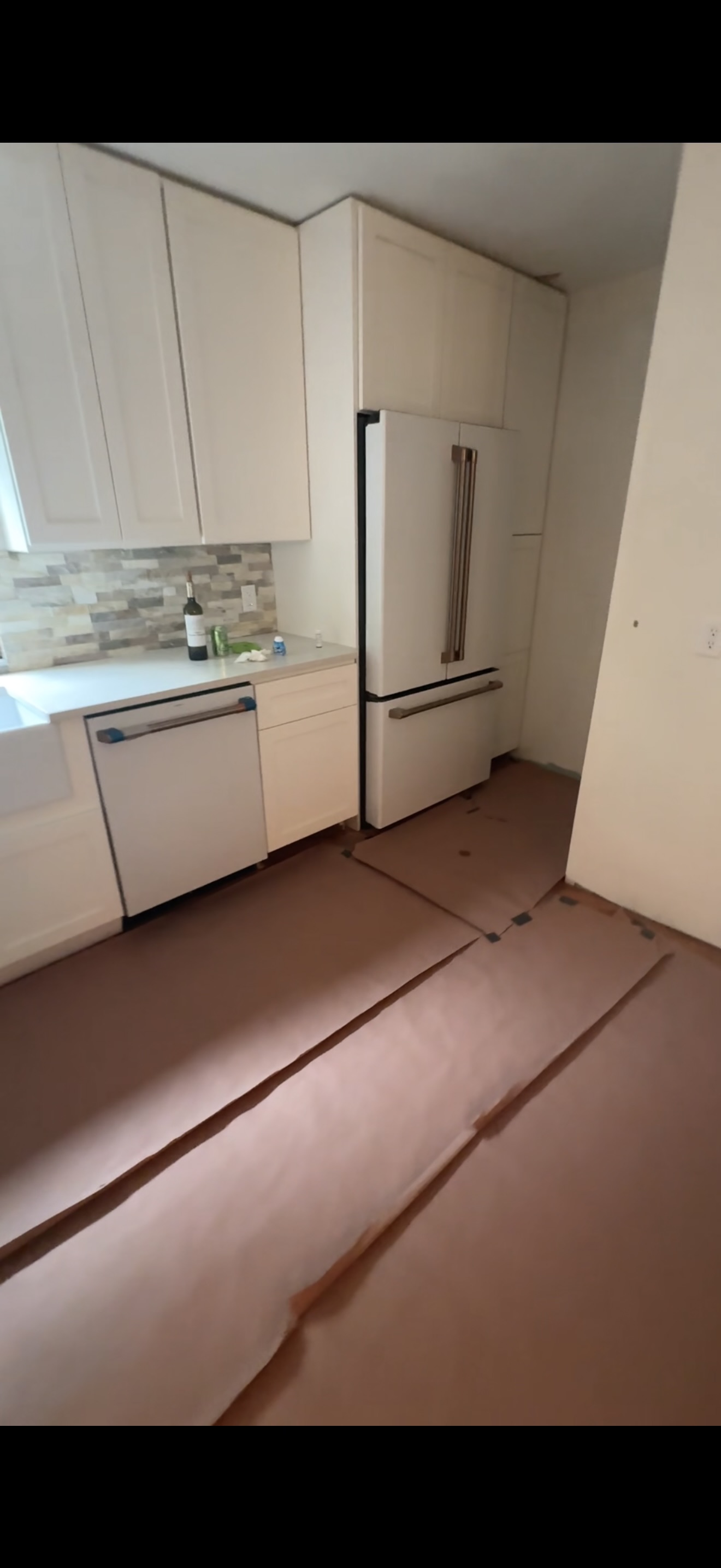 Kitchen remodel complete — new cabinets, backsplash, and appliances