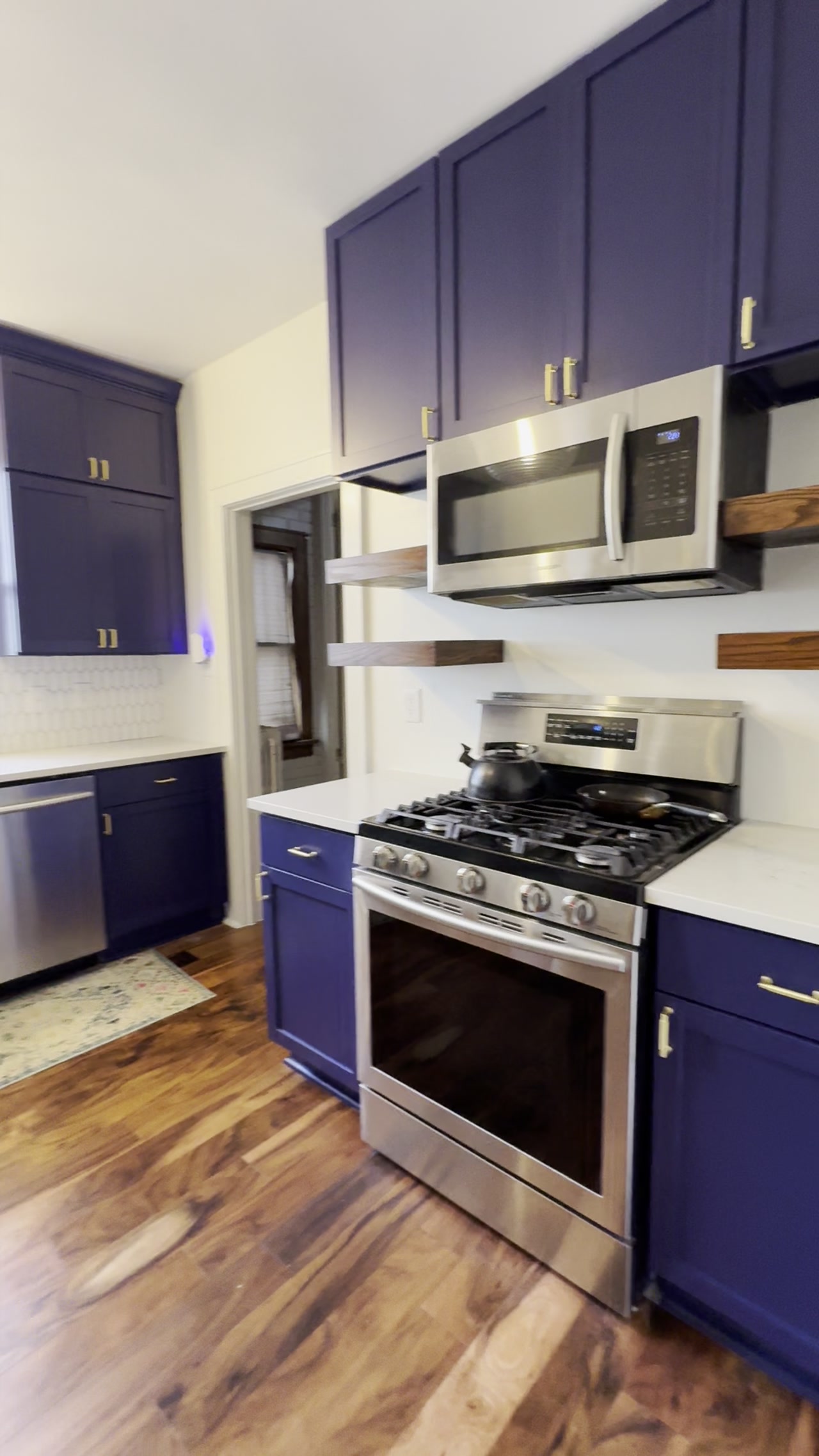 Finished navy kitchen cabinets with stainless appliances